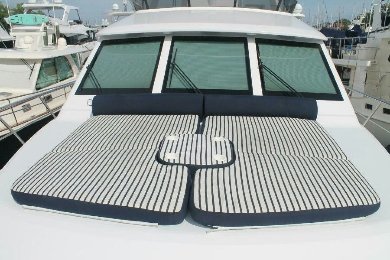 a white boat with a black and white striped cover aboard PARTNERSHIP Yacht for Sale