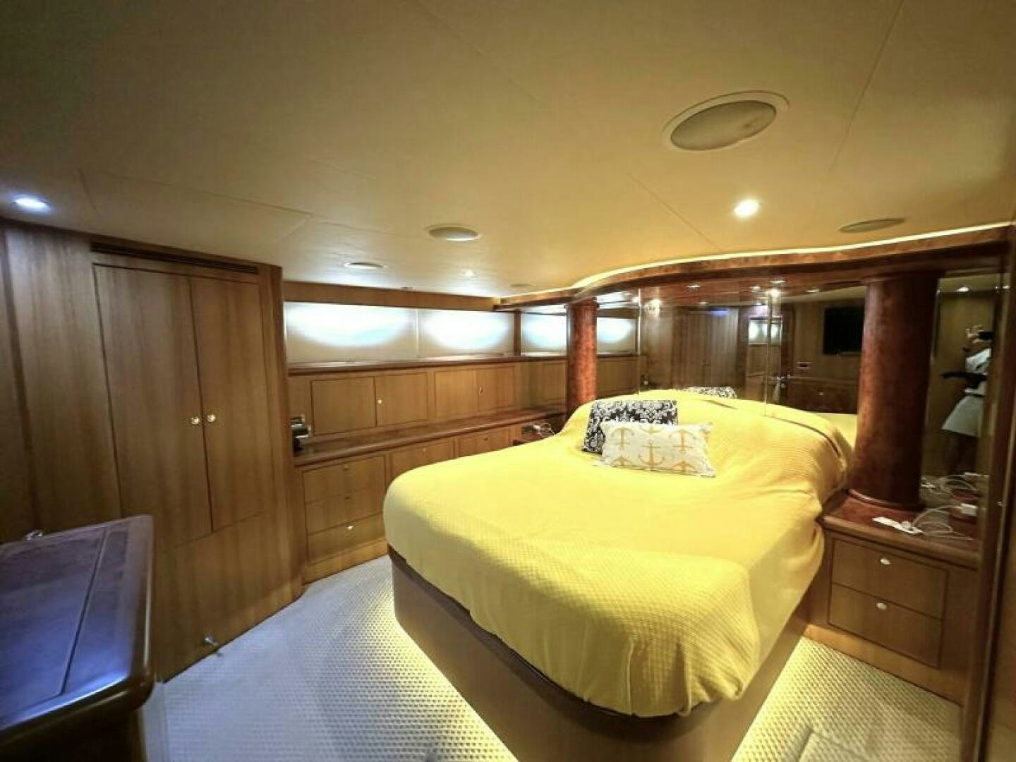 a bedroom with a bed and a wood cabinet aboard PARTNERSHIP Yacht for Sale