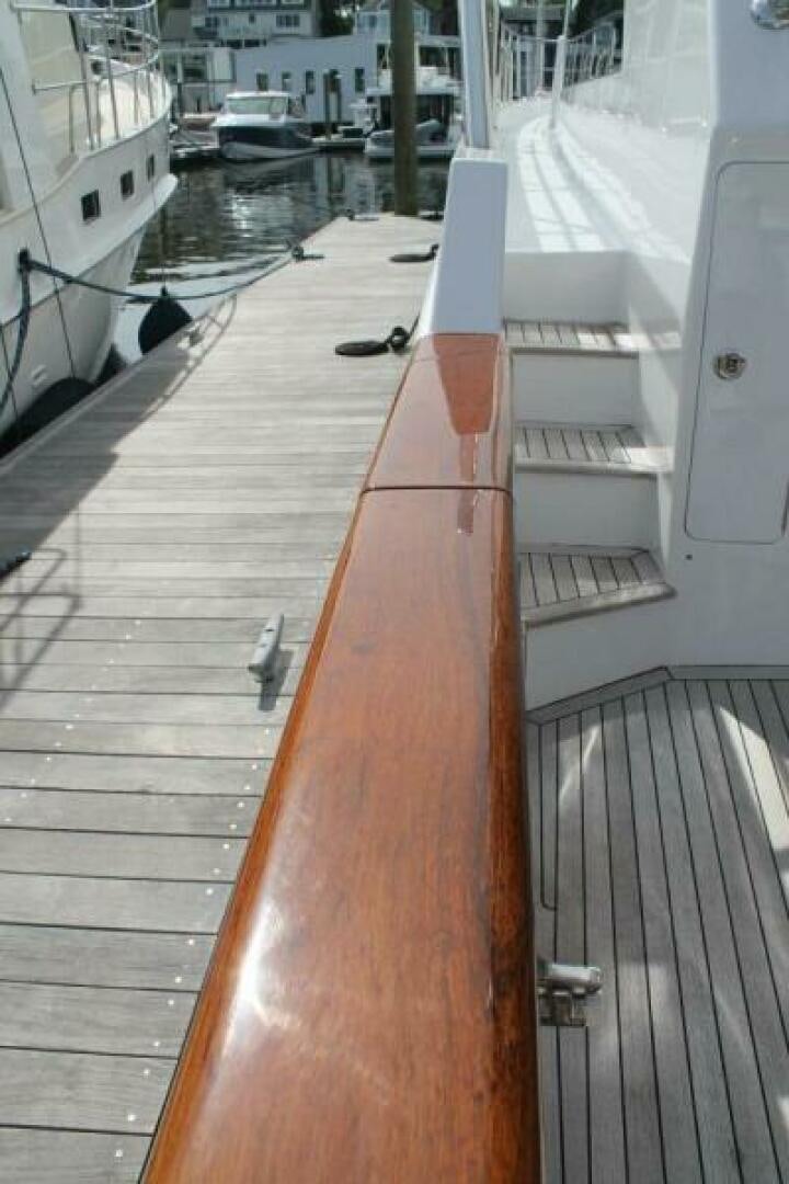 a deck with a railing and boats in the water aboard PARTNERSHIP Yacht for Sale