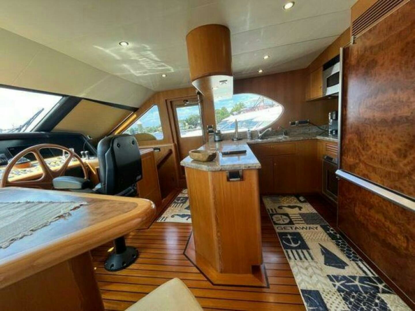 a kitchen with a wood stove and wood cabinets aboard PARTNERSHIP Yacht for Sale