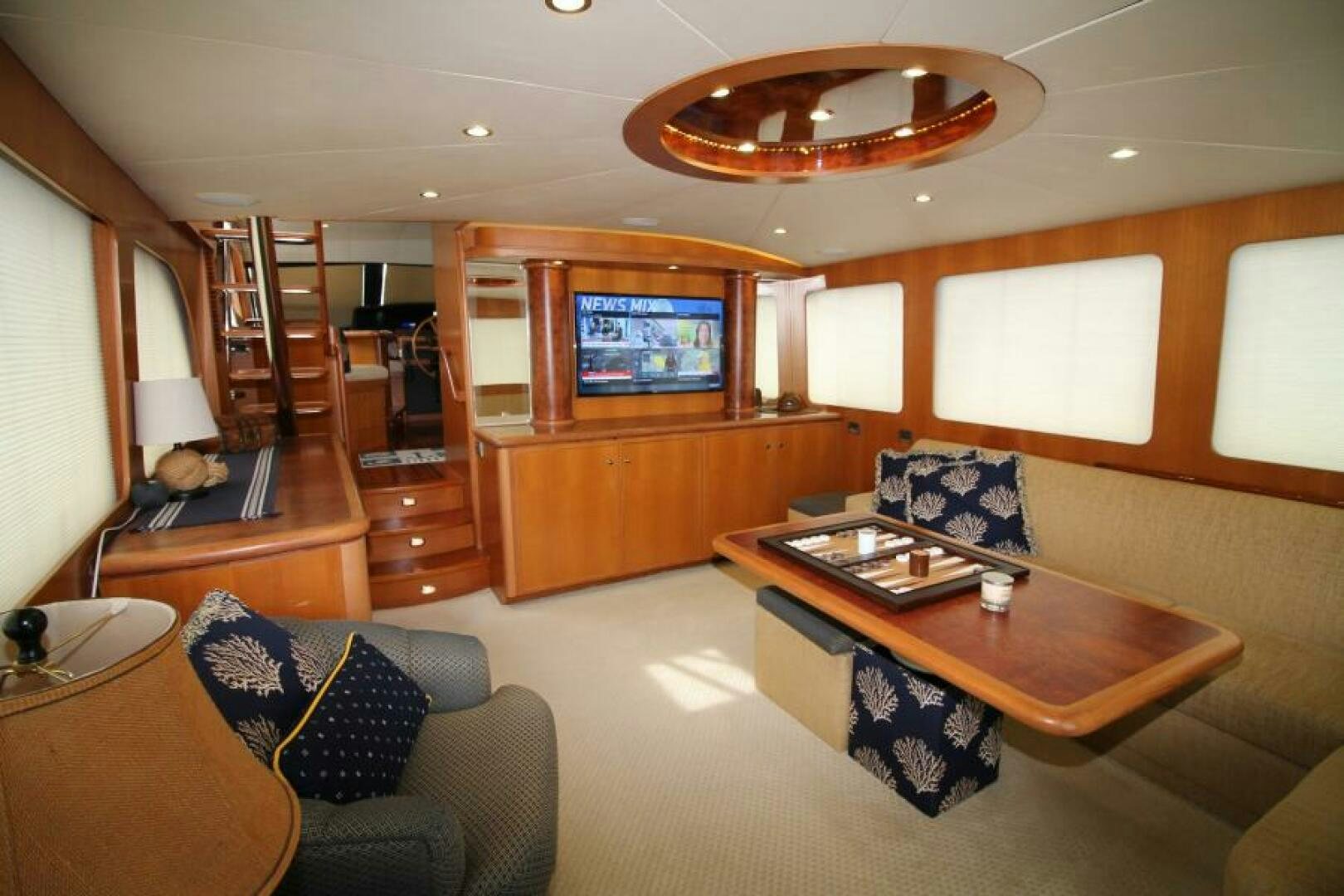 a living room with a table and couches aboard PARTNERSHIP Yacht for Sale