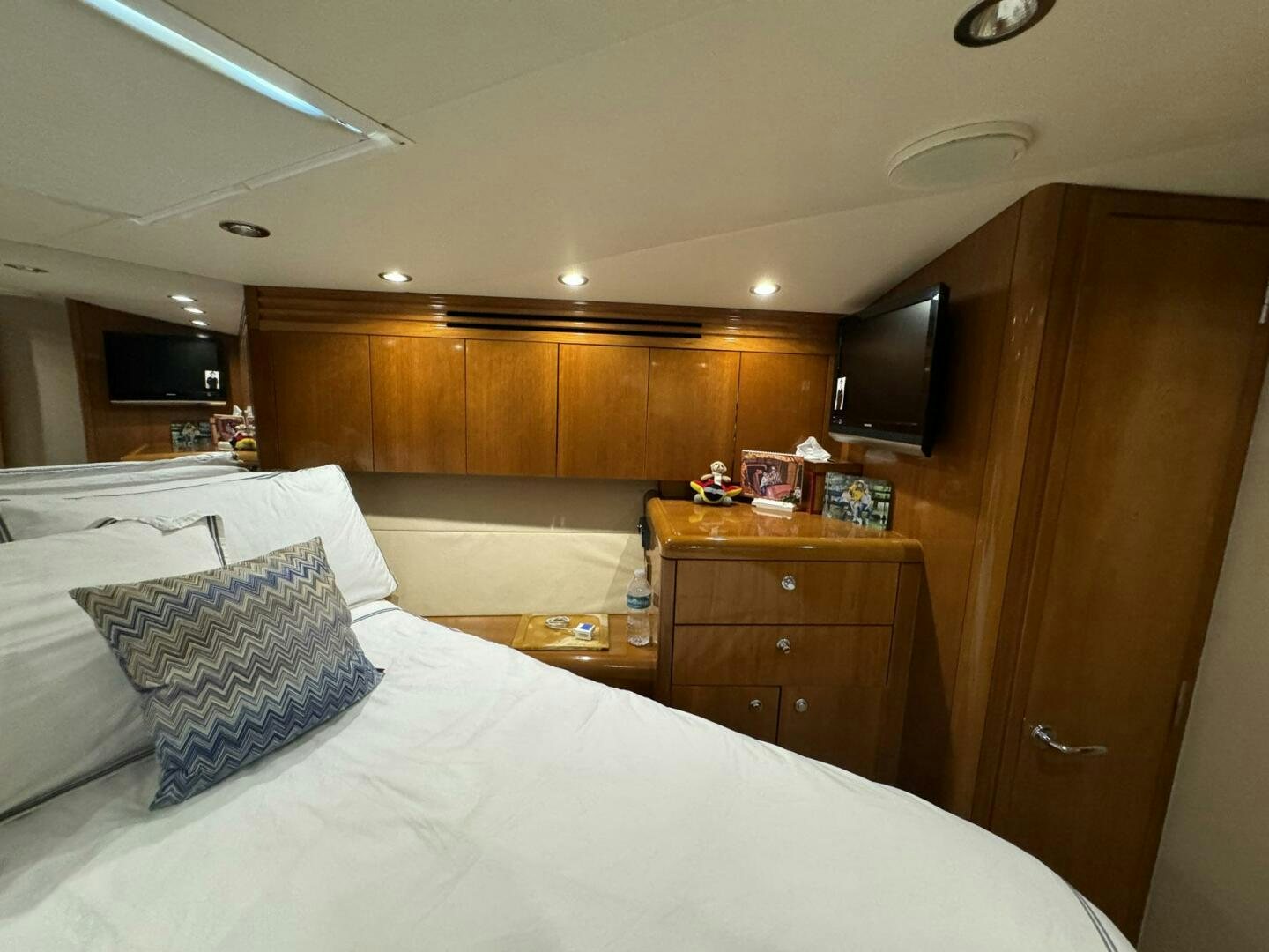 a bedroom with a bed and a tv on the wall aboard MRS. Z Yacht for Sale