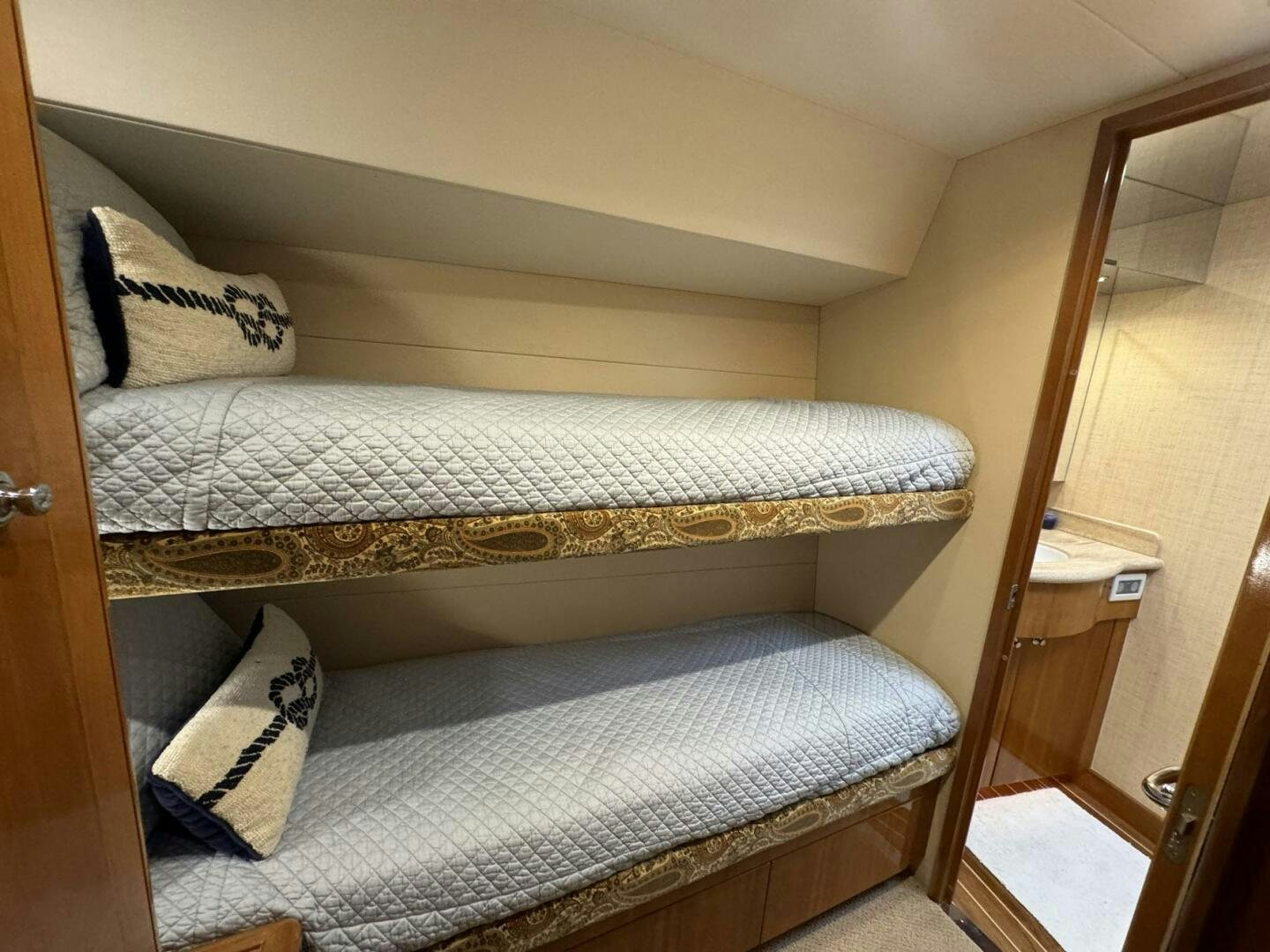 a bed with a wooden headboard aboard MRS. Z Yacht for Sale
