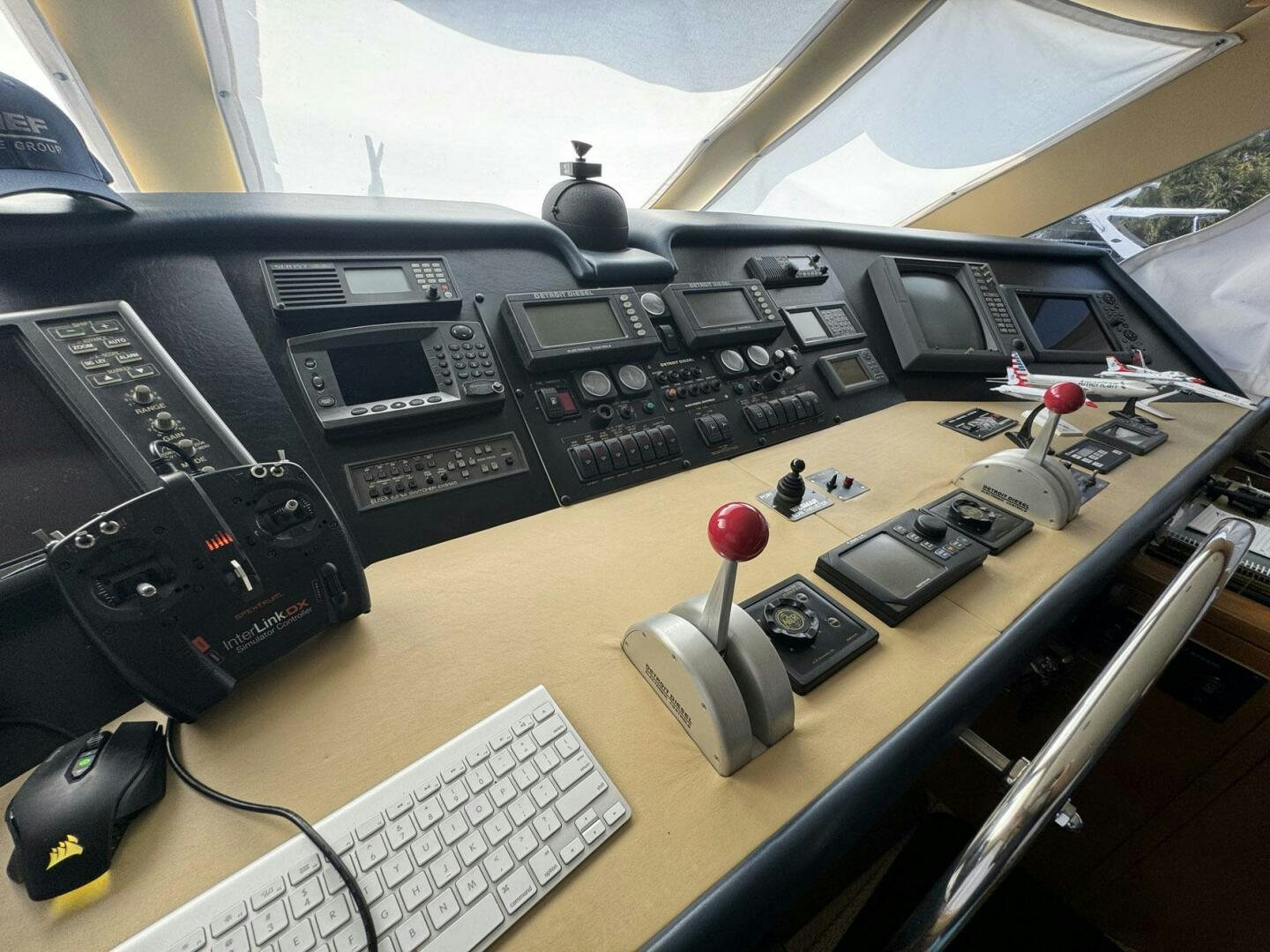 a black device with buttons and a red ball on a desk aboard MRS. Z Yacht for Sale