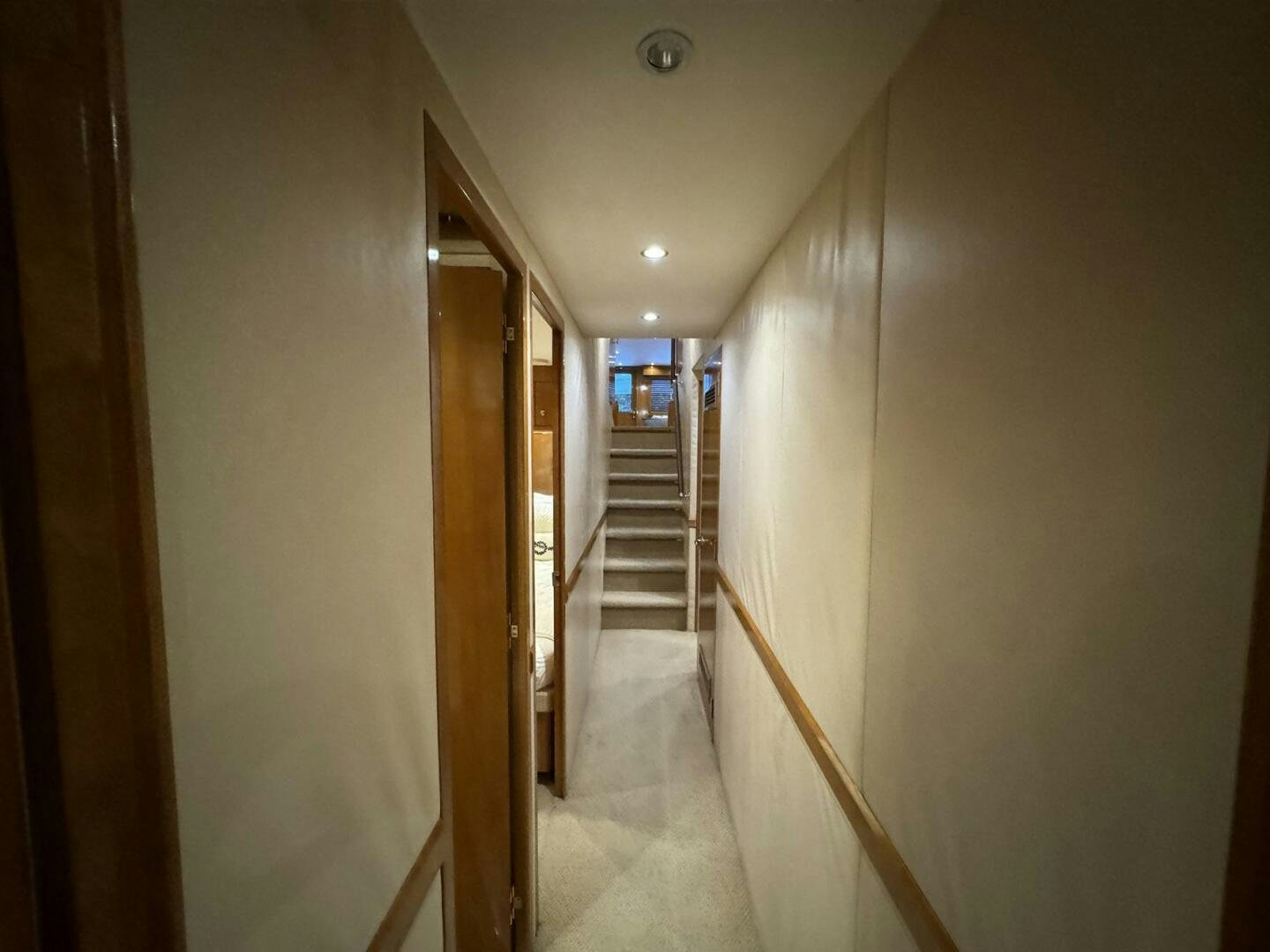 a hallway with a door and a staircase aboard MRS. Z Yacht for Sale