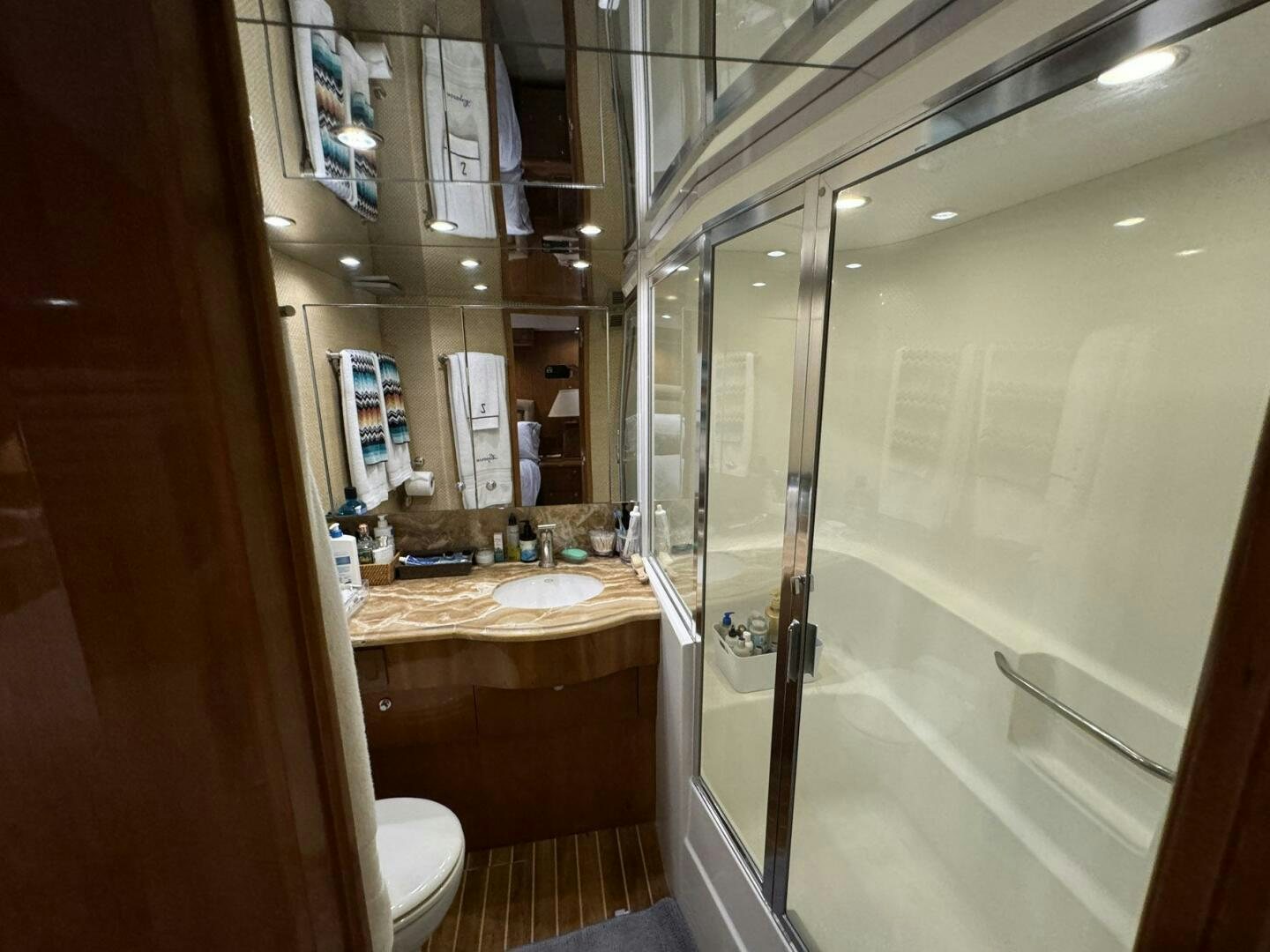 a bathroom with a glass shower aboard MRS. Z Yacht for Sale