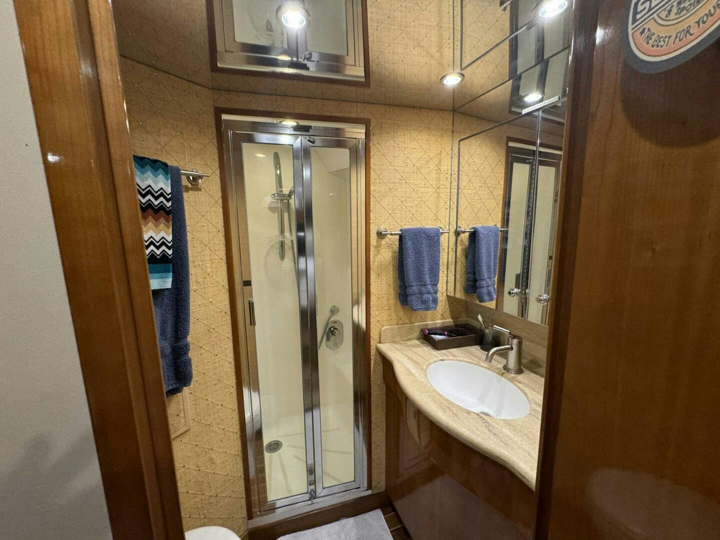 a bathroom with a glass shower aboard MRS. Z Yacht for Sale
