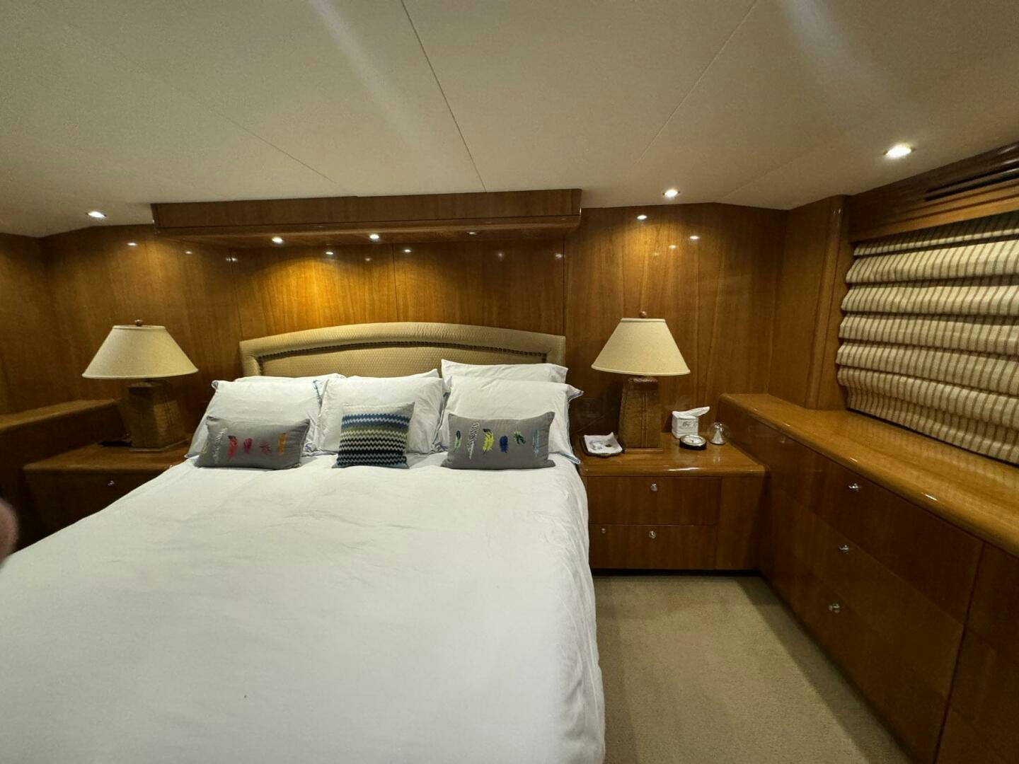 a bed with a white comforter aboard MRS. Z Yacht for Sale