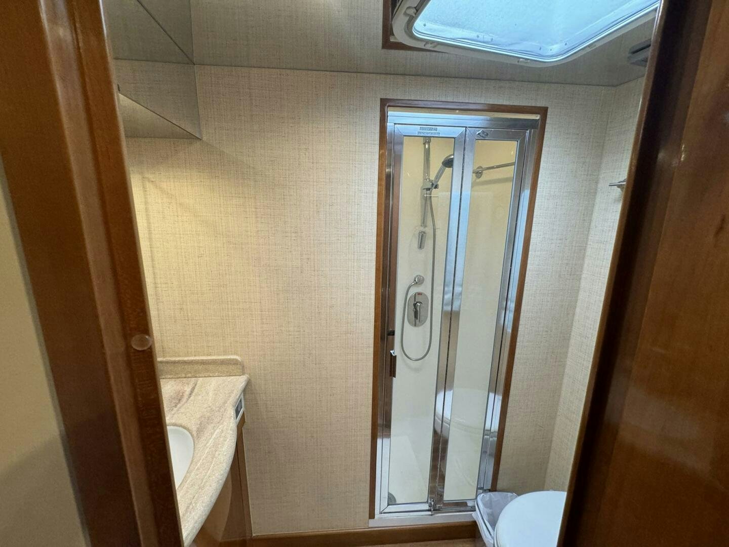 a bathroom with a glass shower door aboard MRS. Z Yacht for Sale