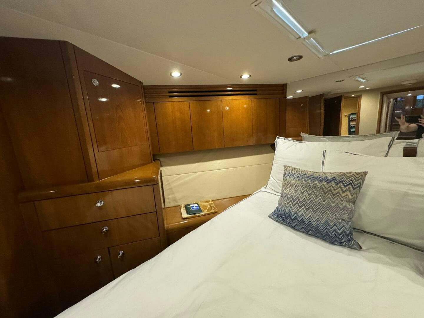 a bed with white sheets aboard MRS. Z Yacht for Sale
