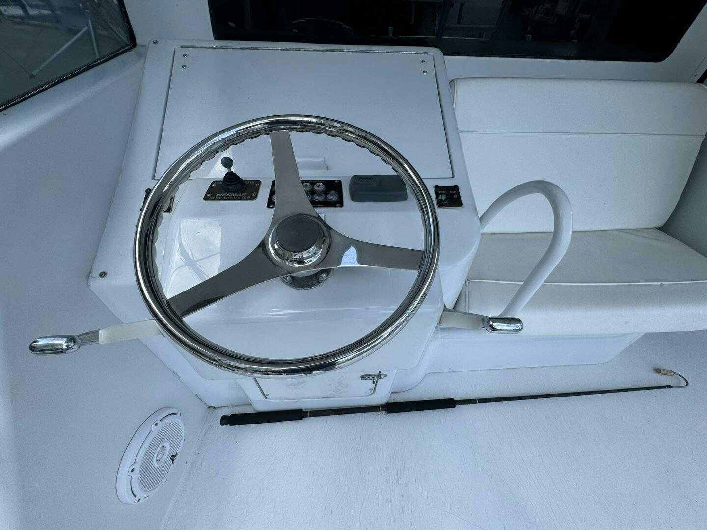 a white car steering wheel aboard MRS. Z Yacht for Sale