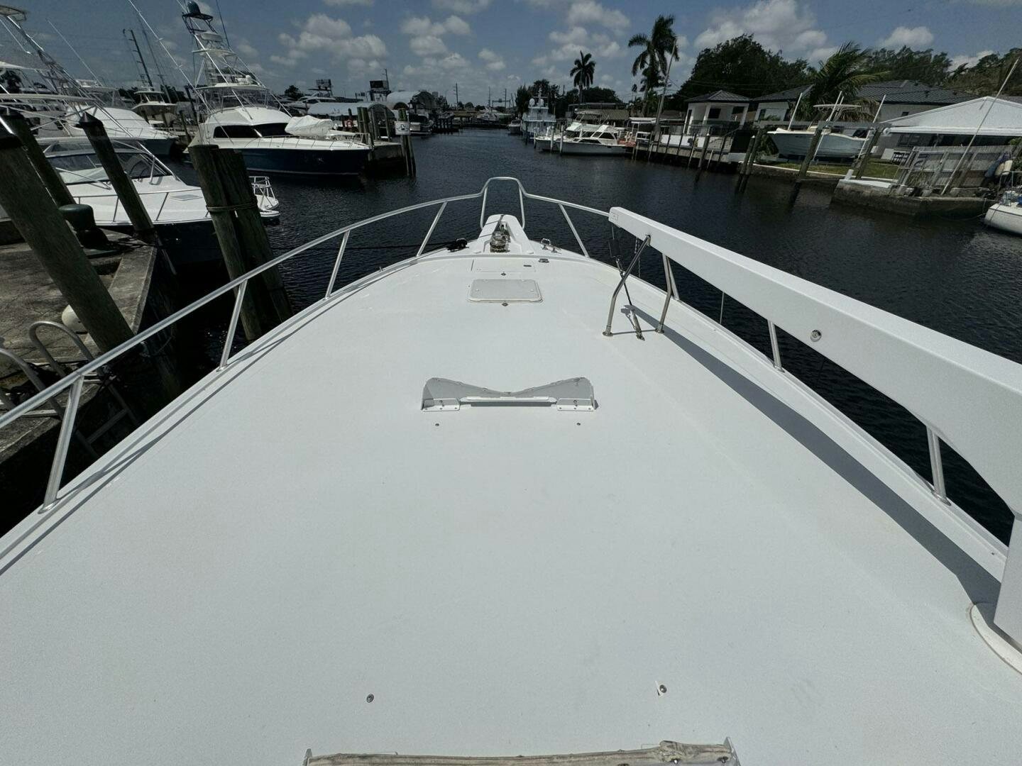 a large white boat in a harbor aboard MRS. Z Yacht for Sale