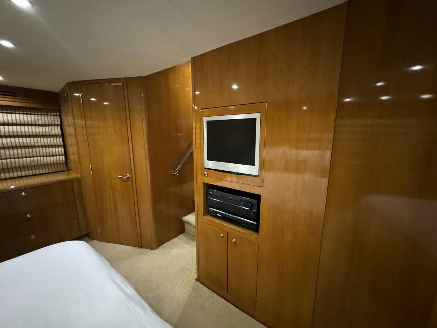 a bedroom with a tv and a bed aboard MRS. Z Yacht for Sale