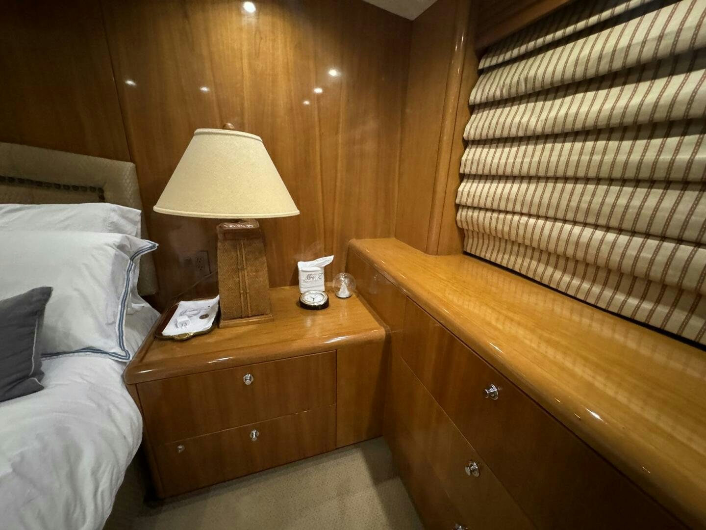 a bed with a lamp on it aboard MRS. Z Yacht for Sale