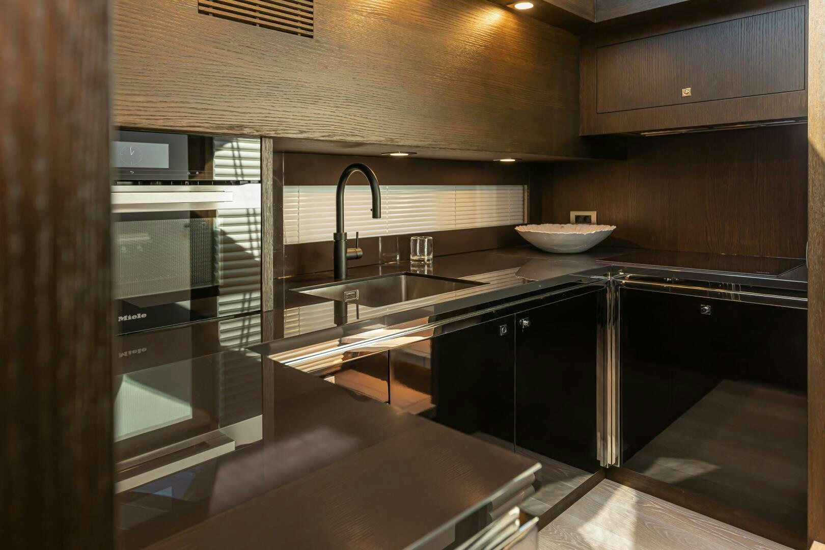a kitchen with a sink and a microwave aboard JUST THE TWO OF US Yacht for Sale