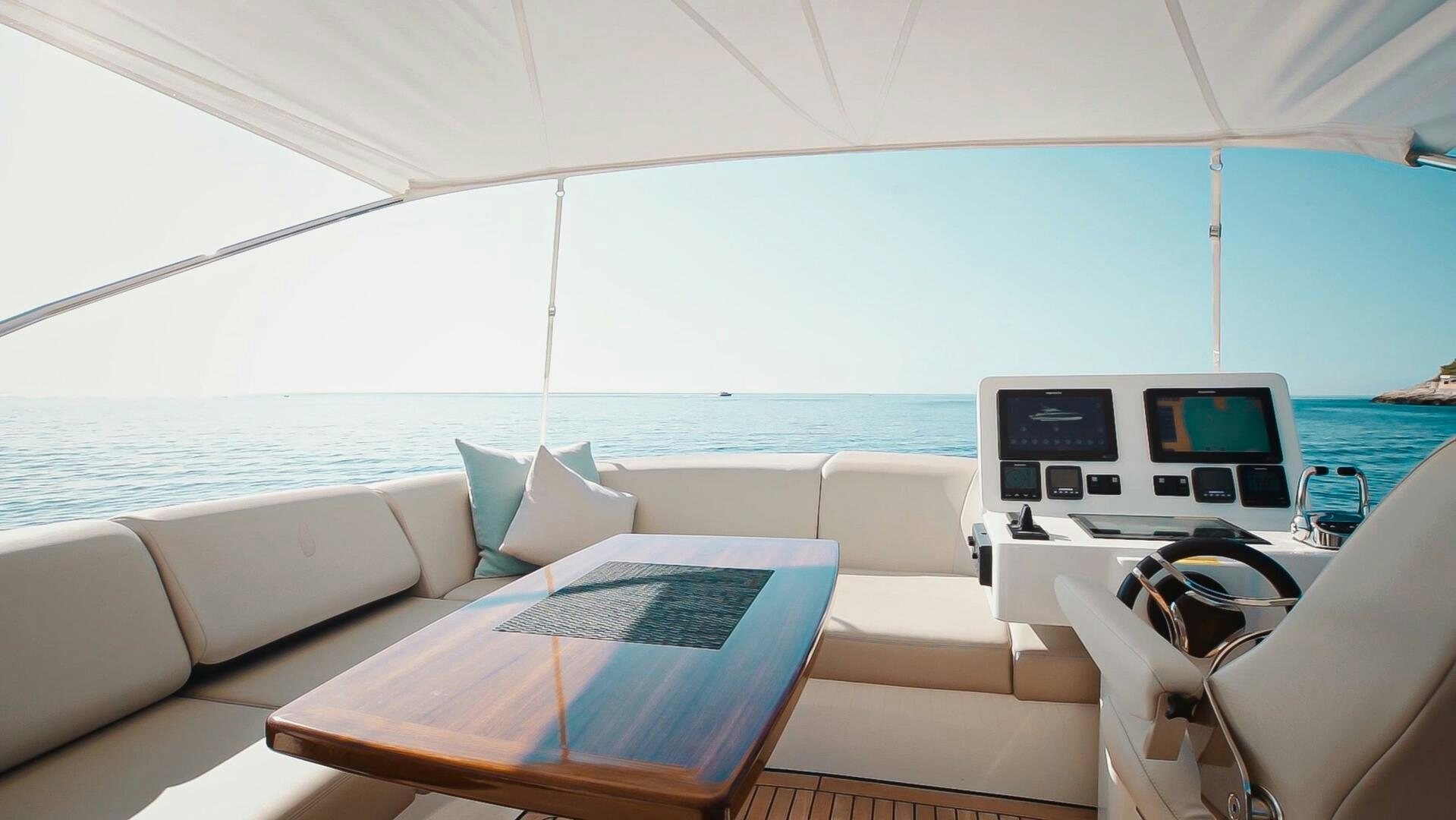 a large white boat with a table and chairs on it aboard JUST THE TWO OF US Yacht for Sale