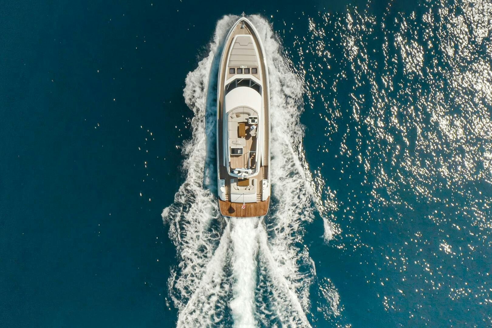 a white and gold boat in the water aboard JUST THE TWO OF US Yacht for Sale