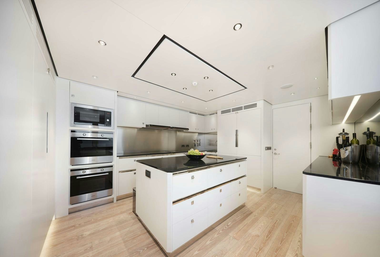 a kitchen with white cabinets aboard PANTERA 44 Yacht for Sale