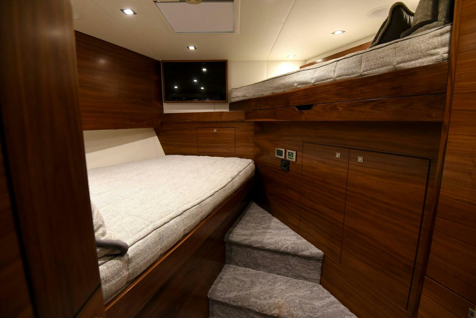 a bed with a wood cabinet aboard AMANDA P Yacht for Sale