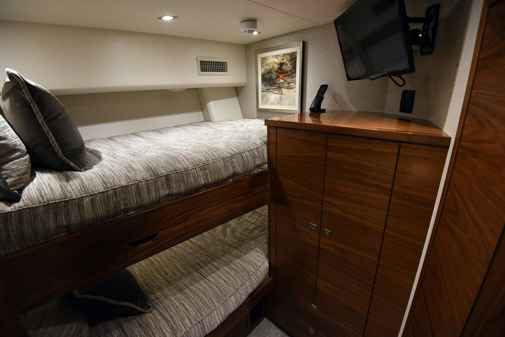 a bedroom with a bed and a television aboard AMANDA P Yacht for Sale