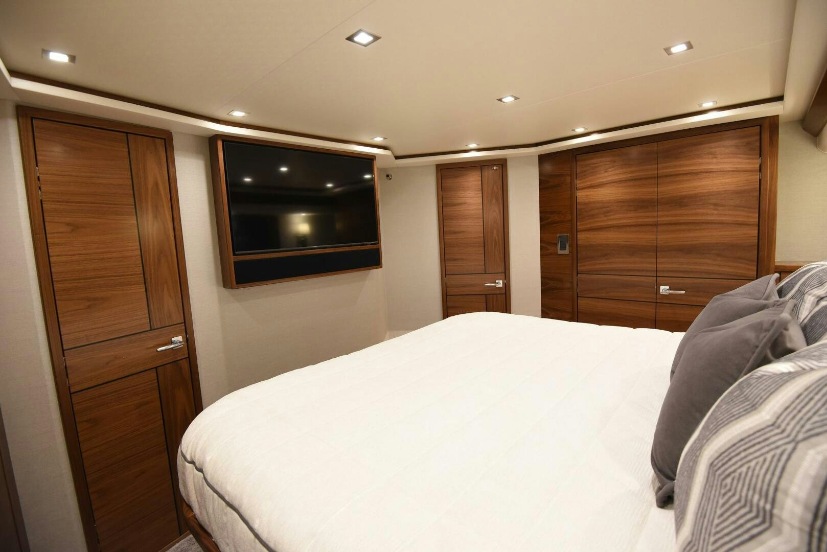 a bedroom with a bed and a television aboard AMANDA P Yacht for Sale