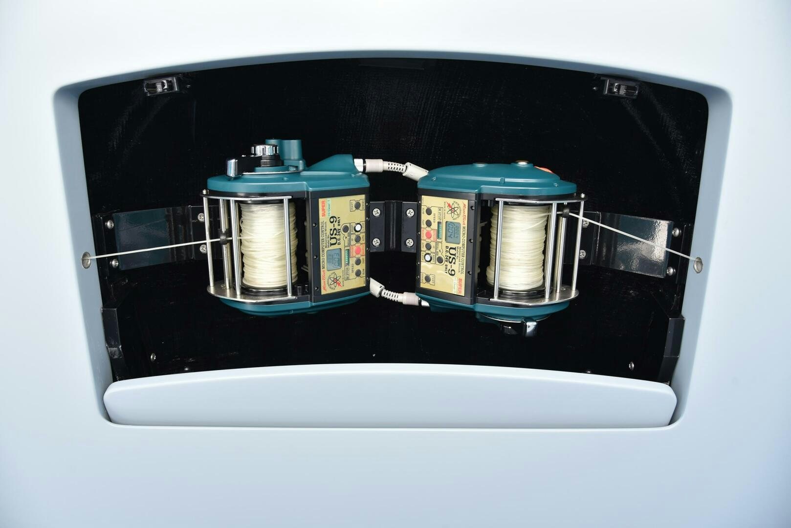 a black rectangular device with a green lid and a blue lid aboard AMANDA P Yacht for Sale