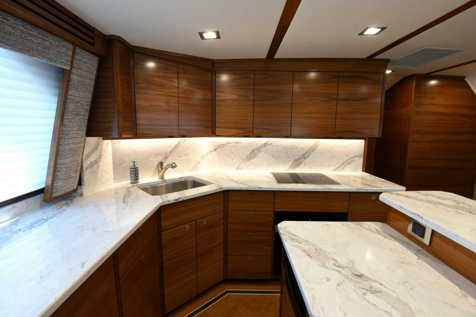 a kitchen with wooden cabinets aboard AMANDA P Yacht for Sale