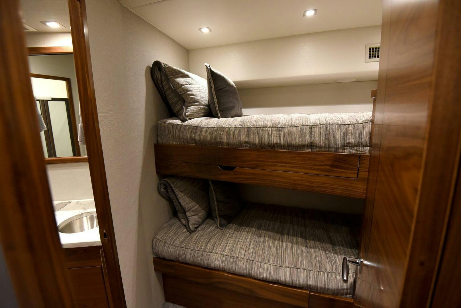 a bed with a chair and a sink aboard AMANDA P Yacht for Sale