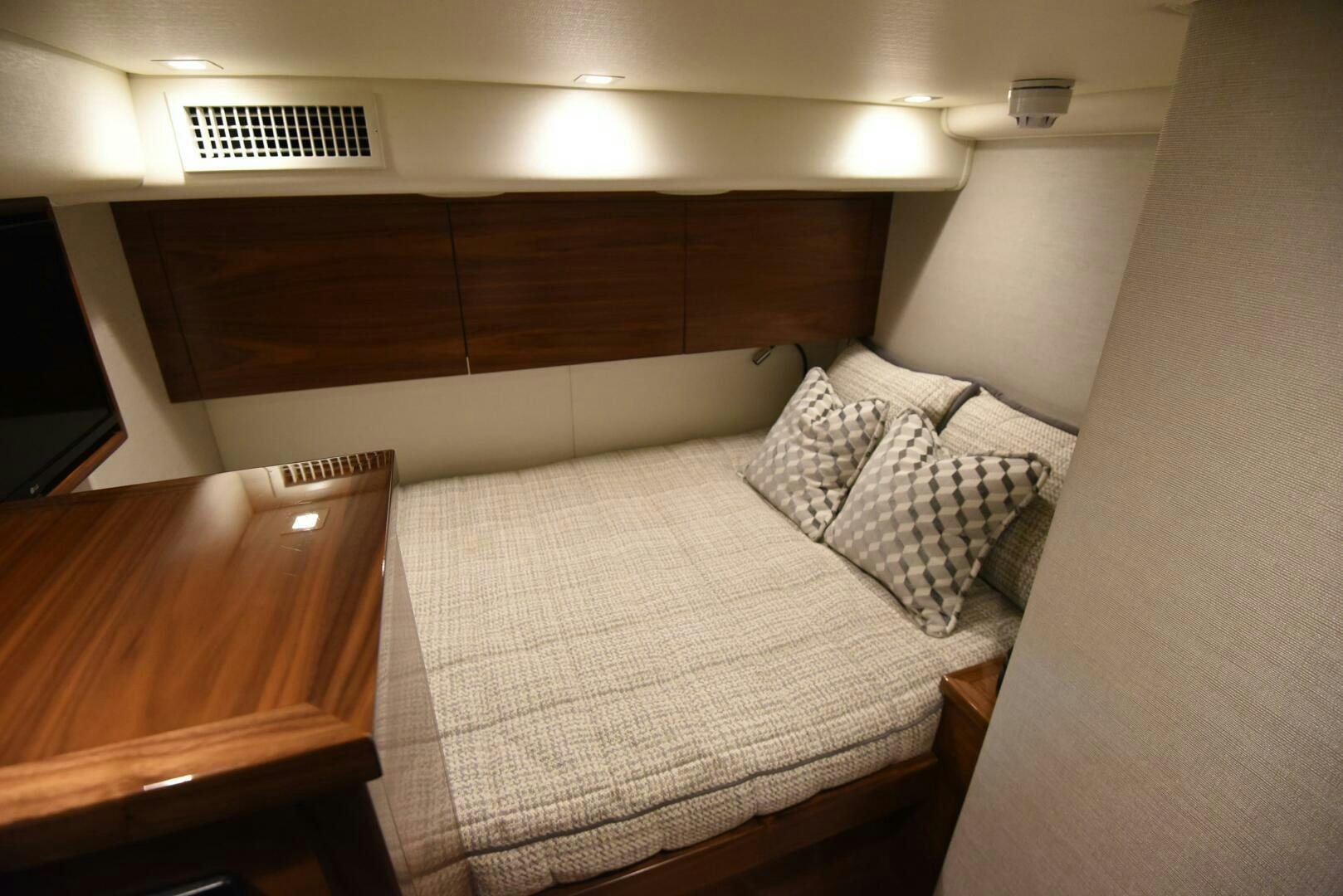 a bed with a white comforter aboard AMANDA P Yacht for Sale