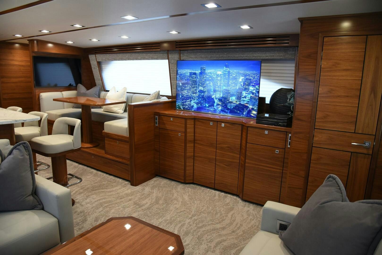 a room with a tv and a cabinet with chairs and a table aboard AMANDA P Yacht for Sale