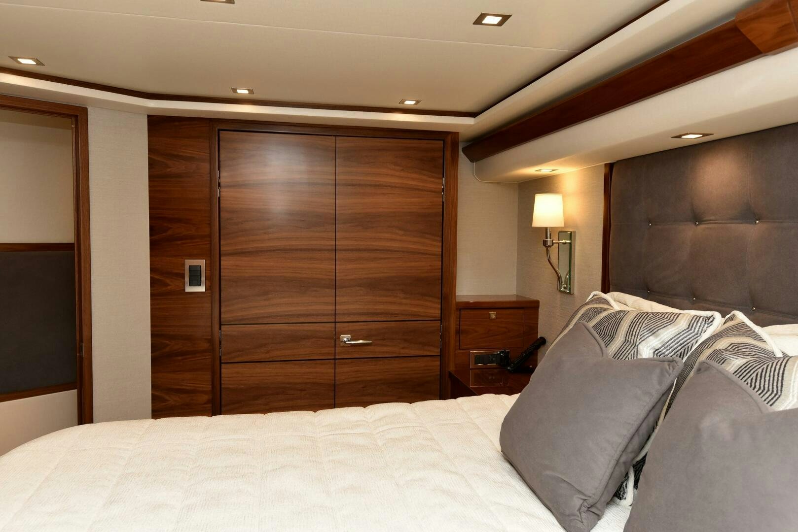 a bed with a wooden door aboard AMANDA P Yacht for Sale