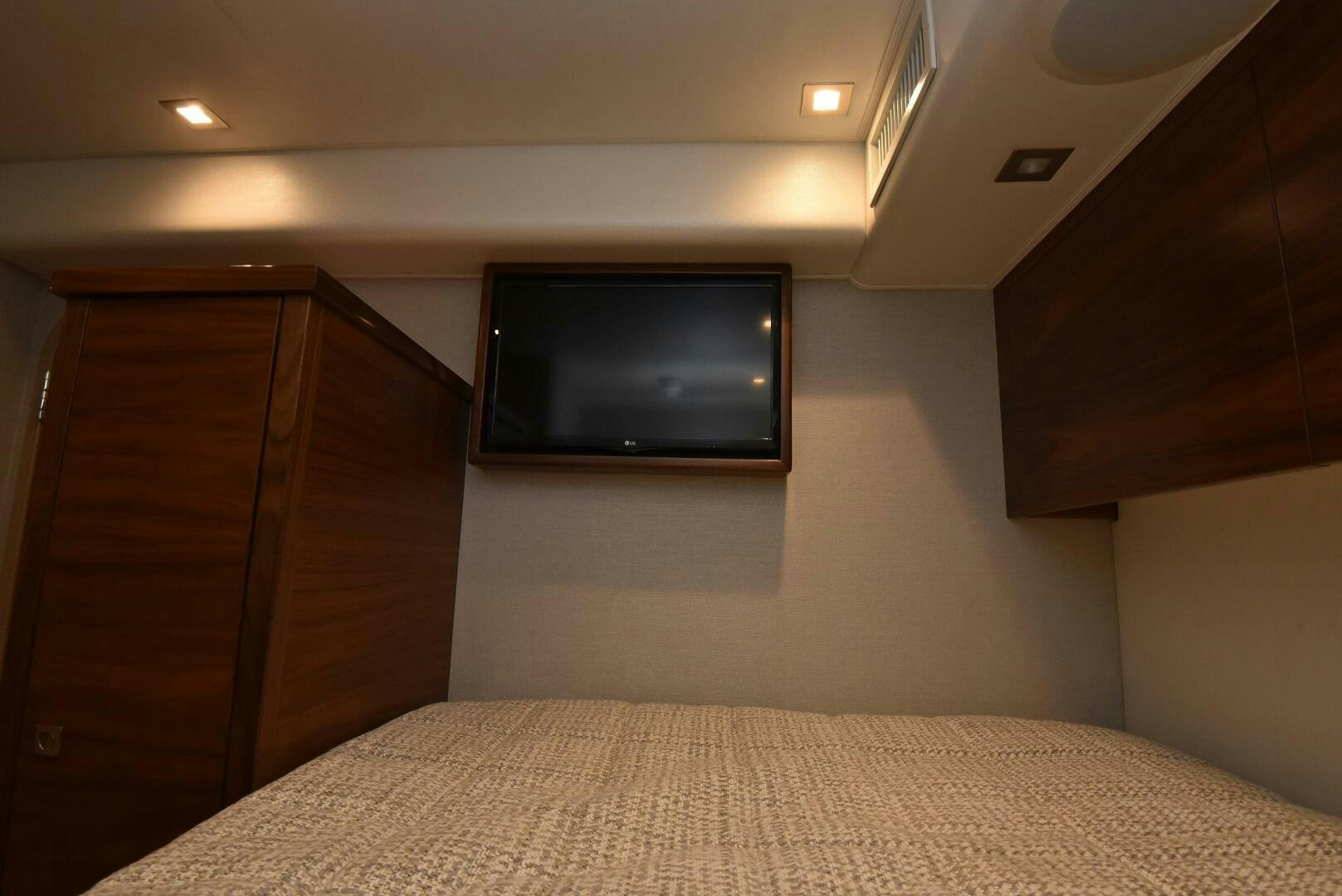a bed with a television on the wall aboard AMANDA P Yacht for Sale