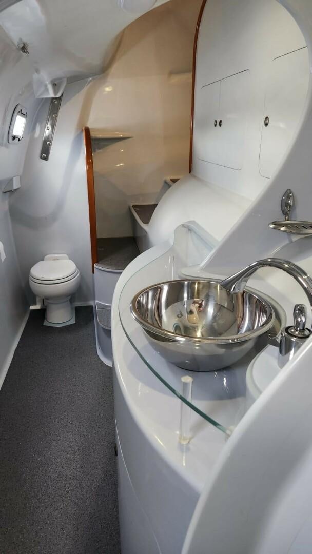 a bathroom with a sink and toilet aboard FAT CAT Yacht for Sale