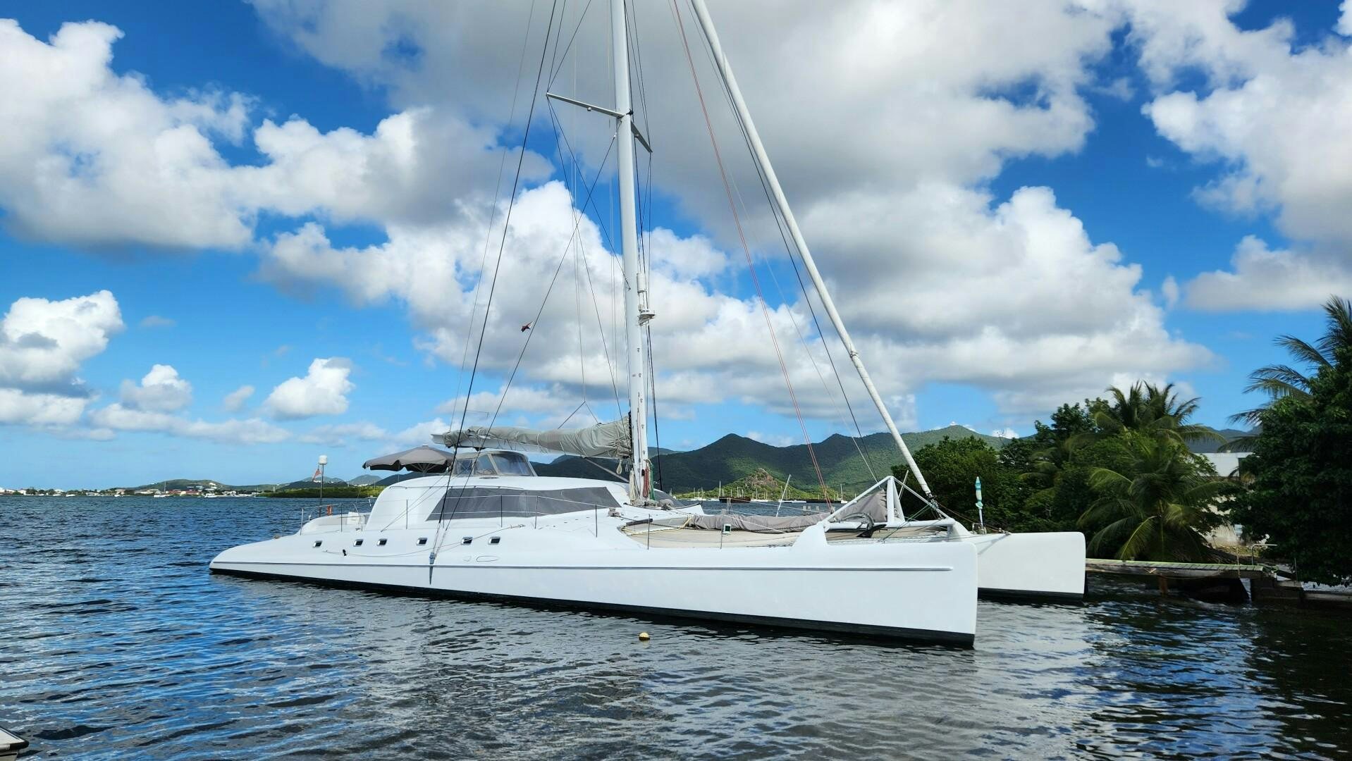 a white boat on the water aboard FAT CAT Yacht for Sale