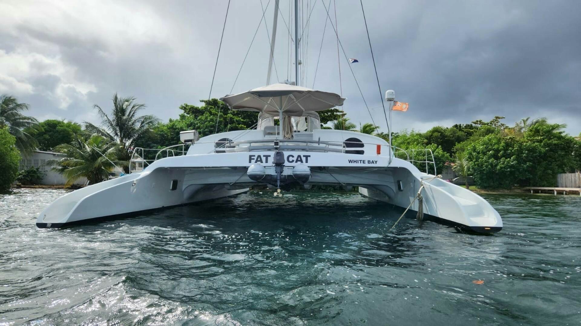 a white boat in the water aboard FAT CAT Yacht for Sale