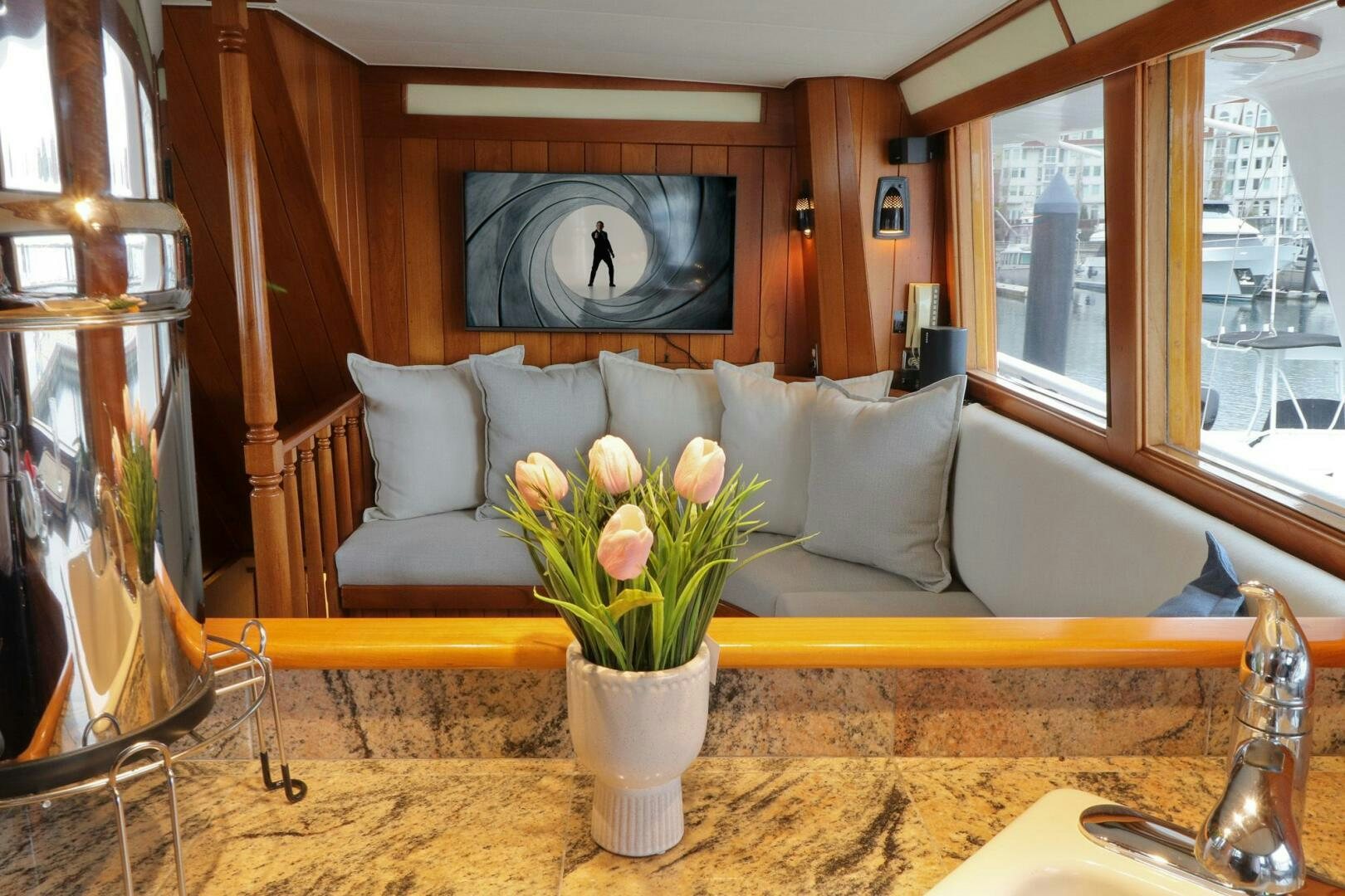 a white vase with flowers on a table aboard PIONEER Yacht for Sale