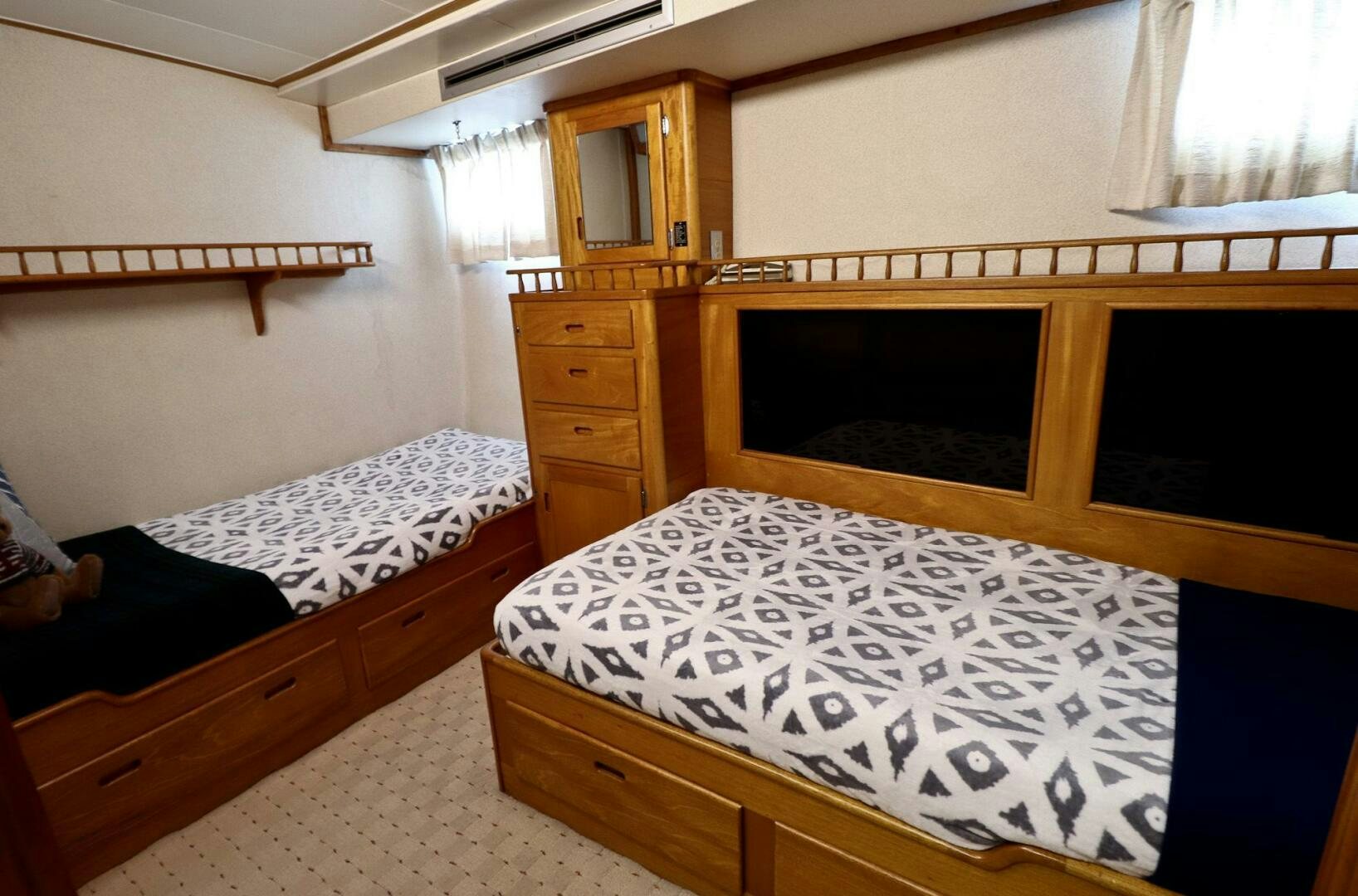 a couple of beds in a room aboard PIONEER Yacht for Sale