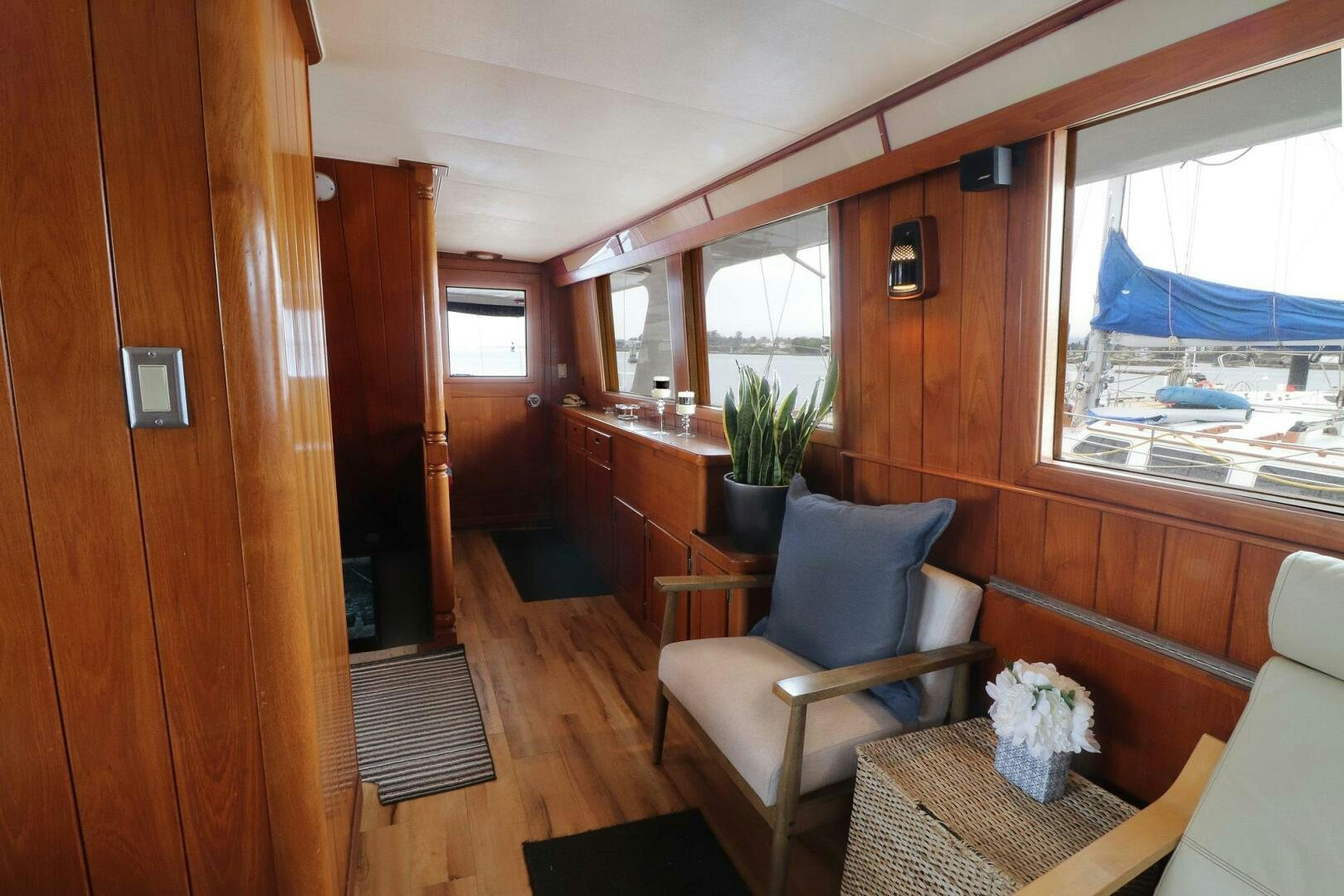 a room with a chair and a table and a window aboard PIONEER Yacht for Sale