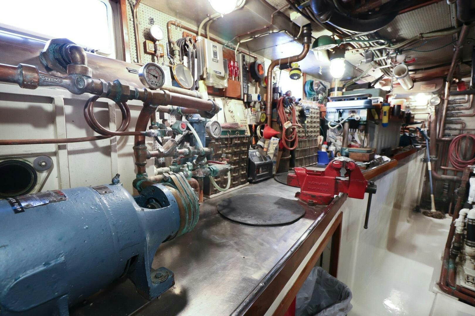a room with many barrels and metal objects on the walls aboard PIONEER Yacht for Sale