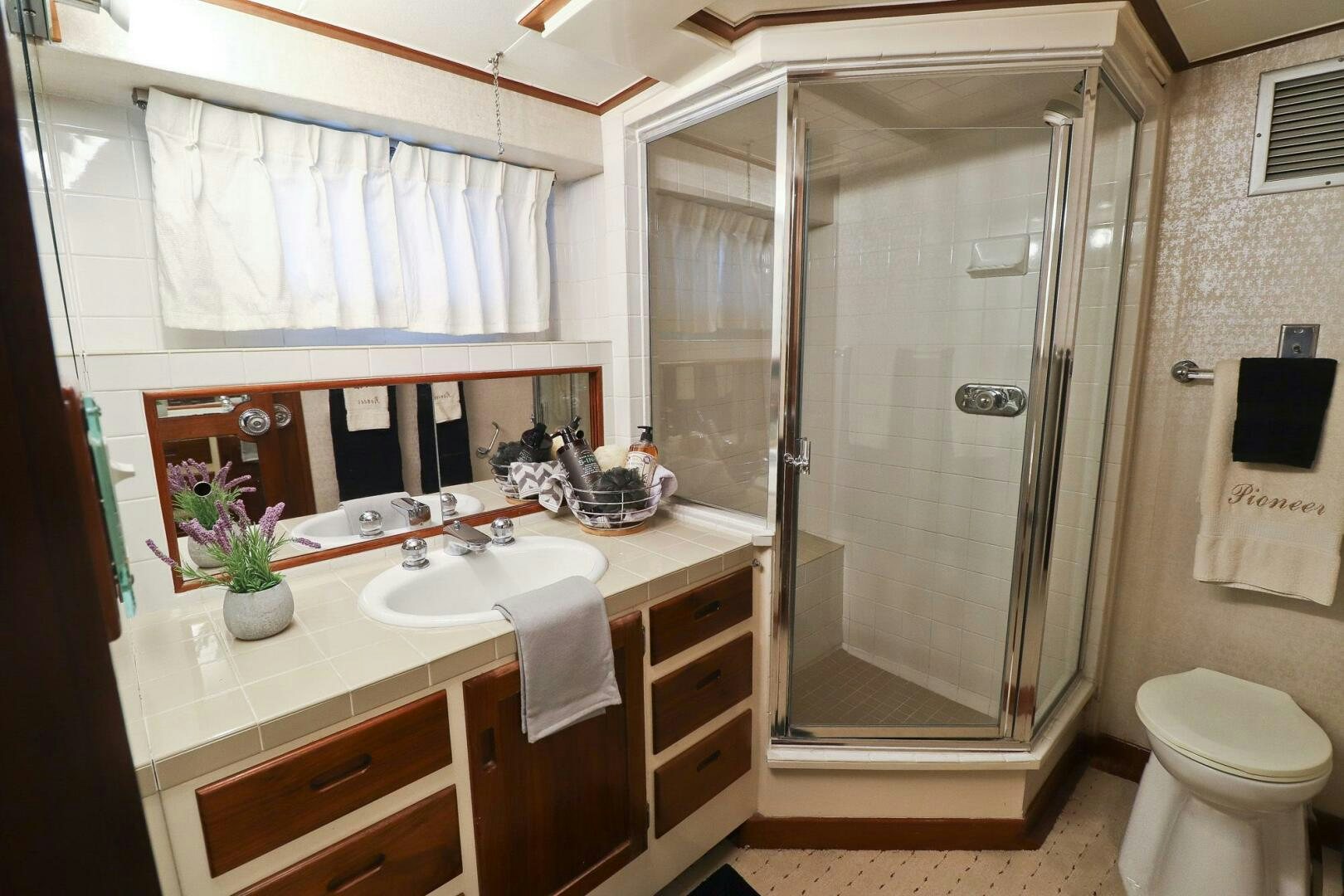 a bathroom with a glass shower aboard PIONEER Yacht for Sale
