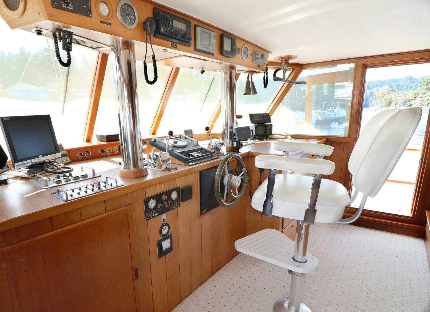a small kitchen with a desk and chairs aboard PIONEER Yacht for Sale