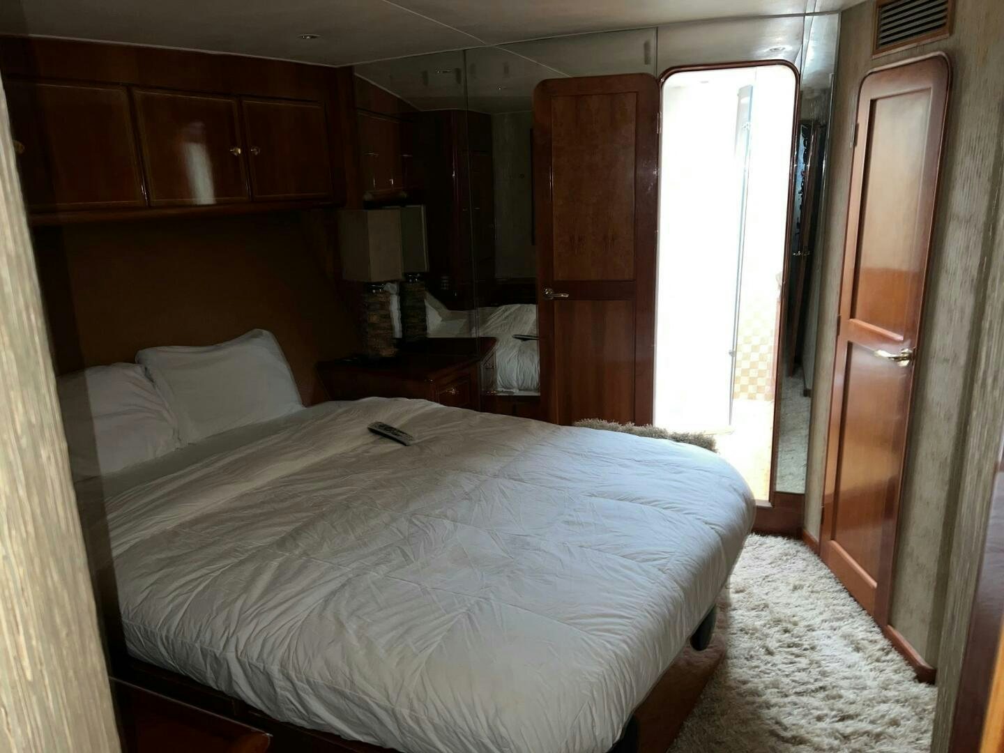 a bedroom with a bed and a closet aboard BUCK-N-BILLS Yacht for Sale