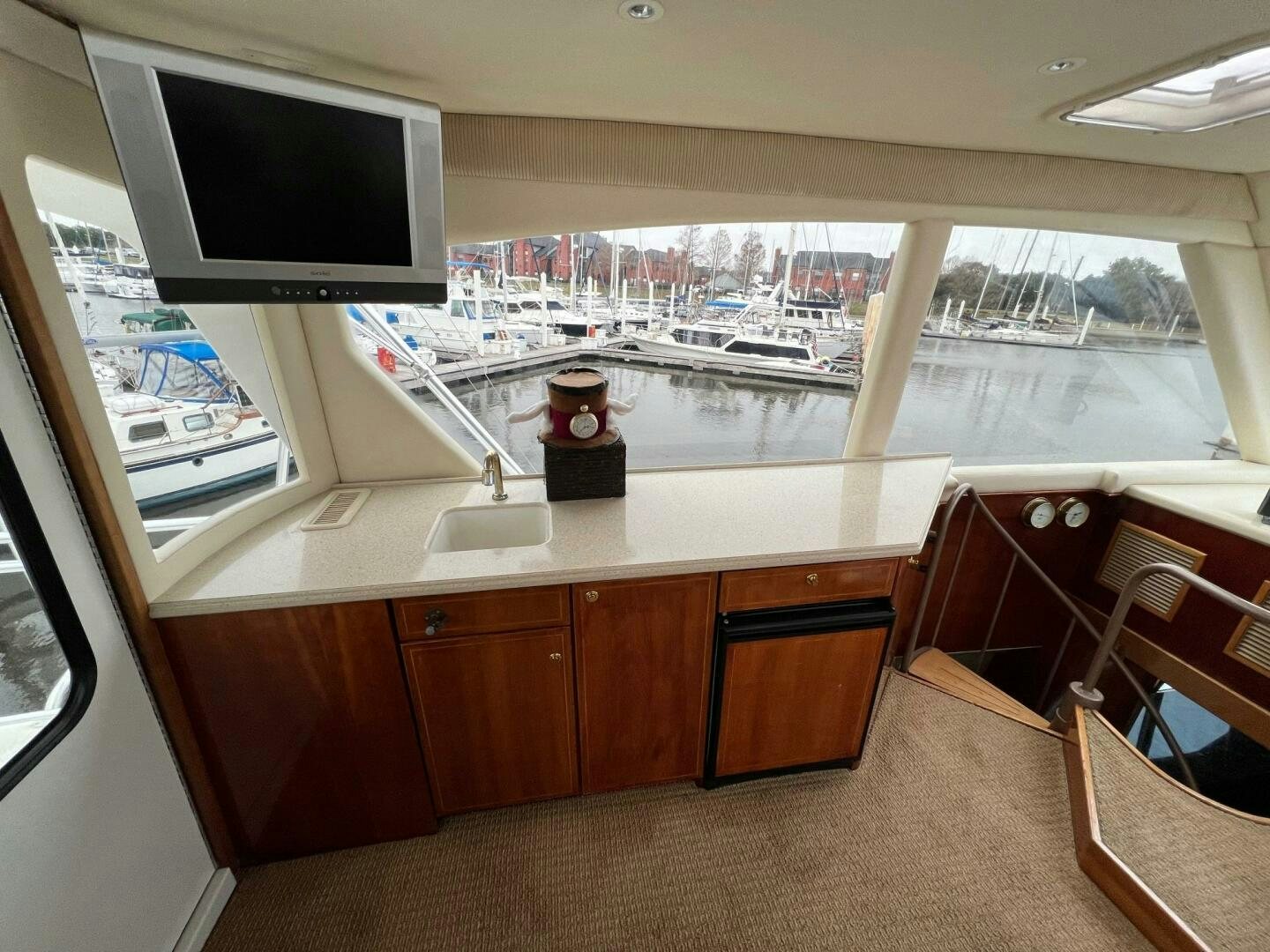 a room with a tv and a table with chairs and a window aboard BUCK-N-BILLS Yacht for Sale
