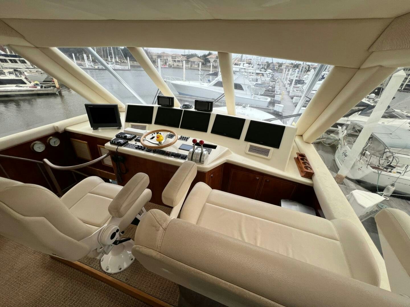 a room with a large window and a table with chairs and a laptop on it aboard BUCK-N-BILLS Yacht for Sale