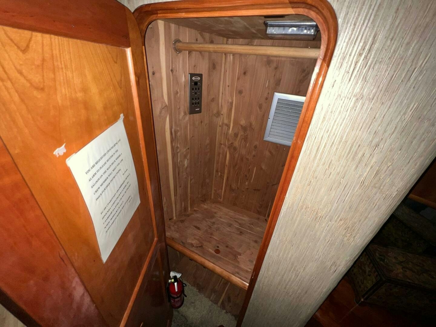 a wood cabinet with a white door aboard BUCK-N-BILLS Yacht for Sale