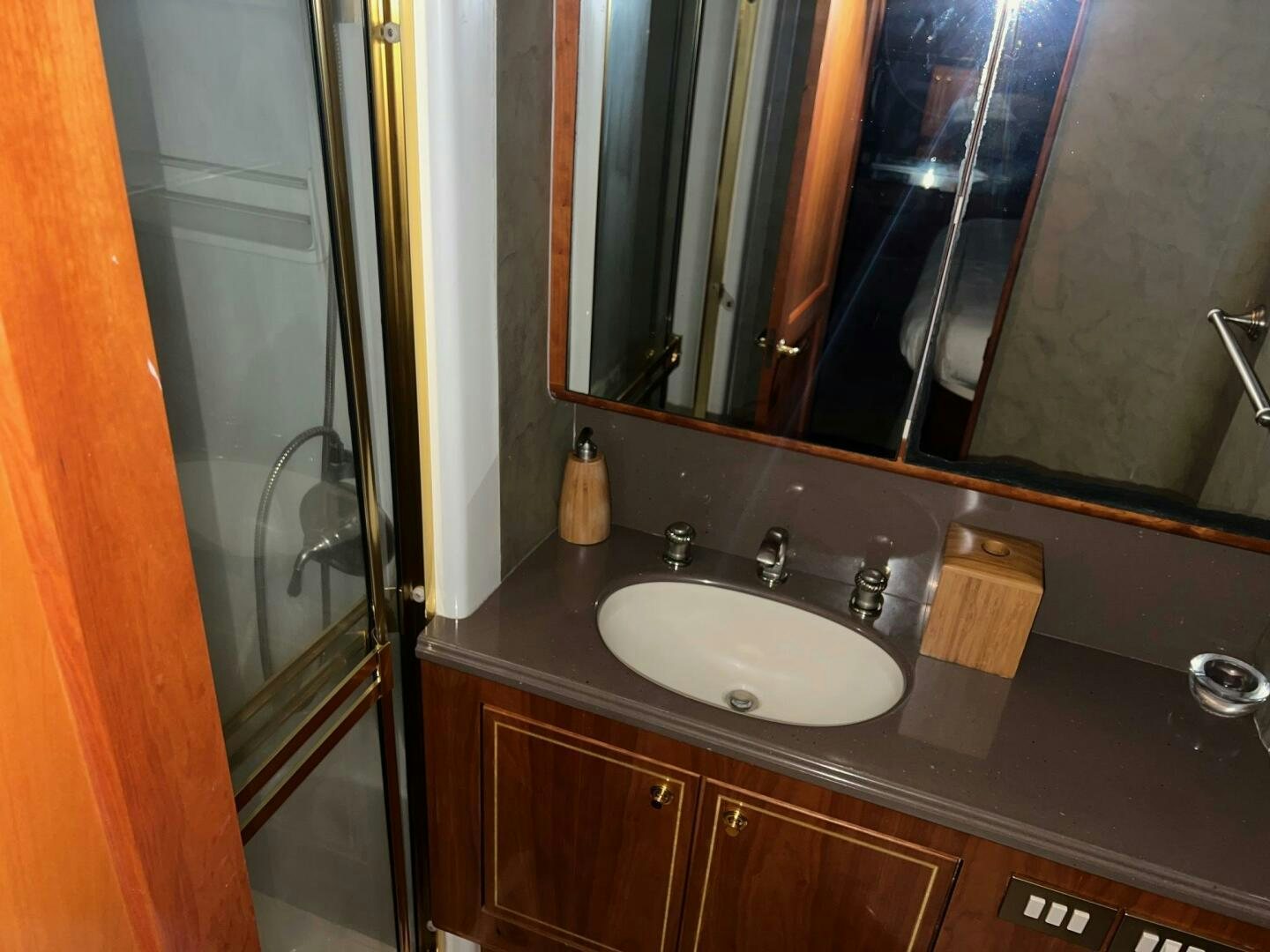 a bathroom with a sink and a mirror aboard BUCK-N-BILLS Yacht for Sale
