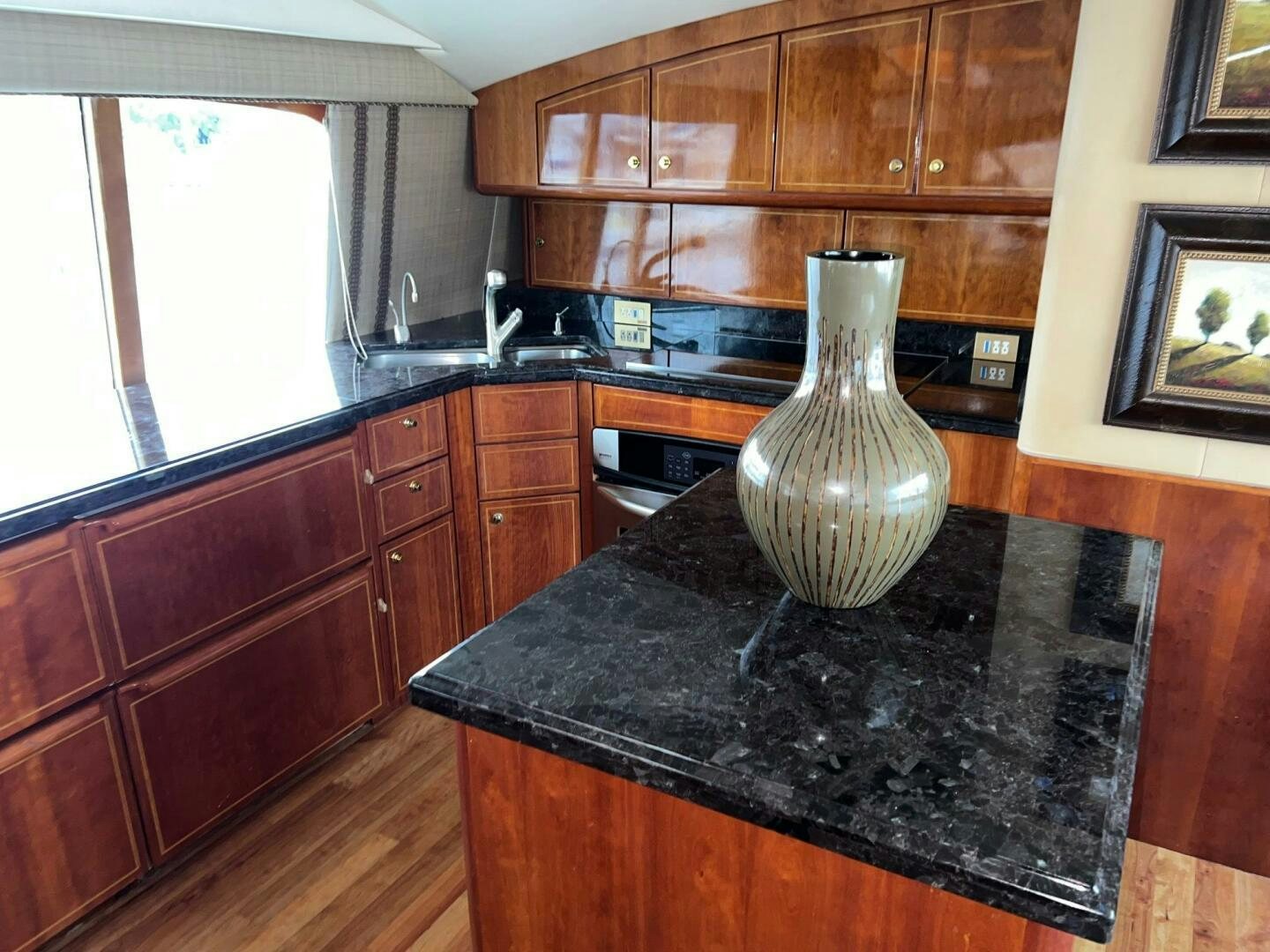 a kitchen with wooden cabinets aboard BUCK-N-BILLS Yacht for Sale