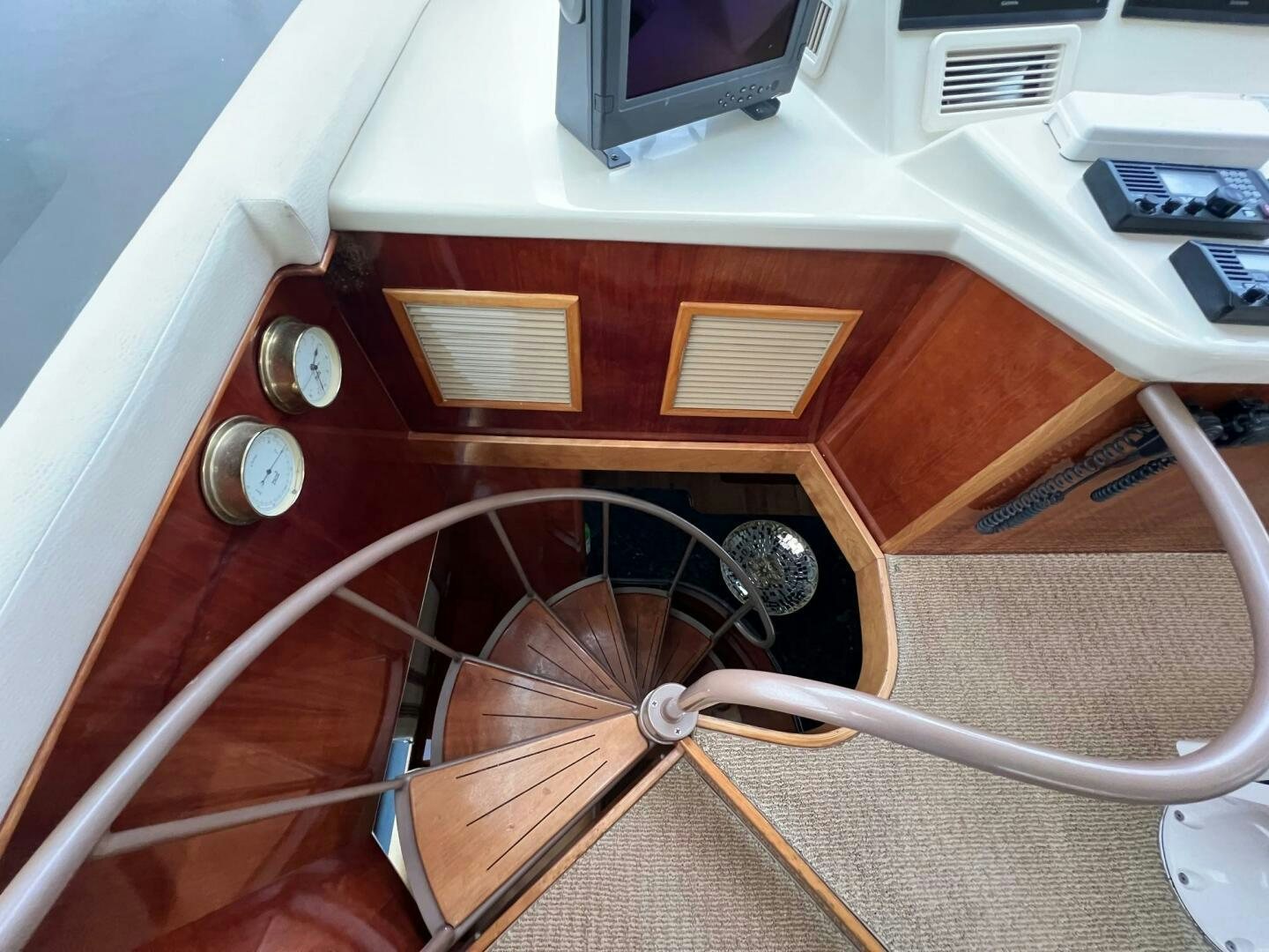a wooden desk with a computer and a radio aboard BUCK-N-BILLS Yacht for Sale