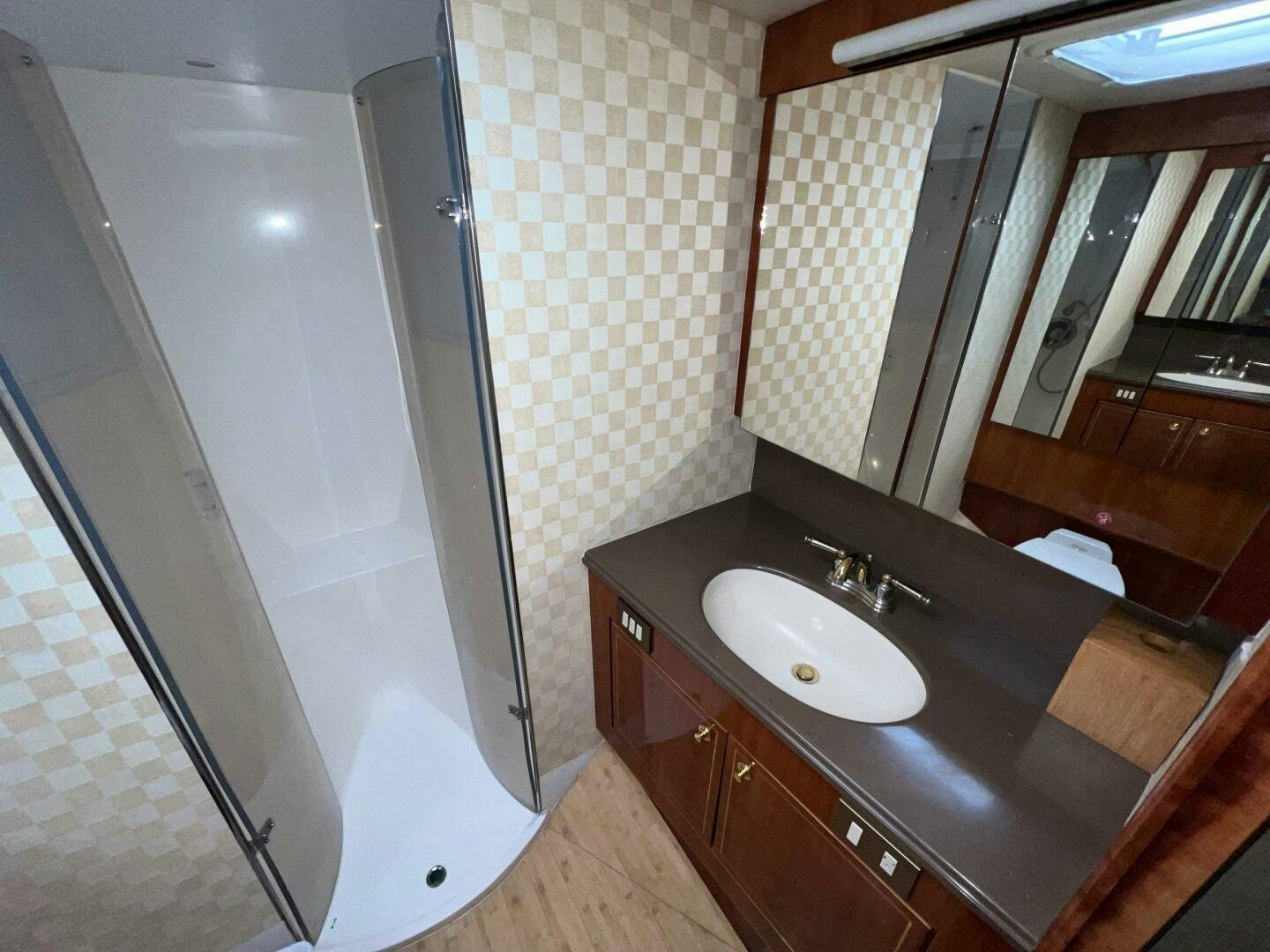 a bathroom with a sink and a shower aboard BUCK-N-BILLS Yacht for Sale