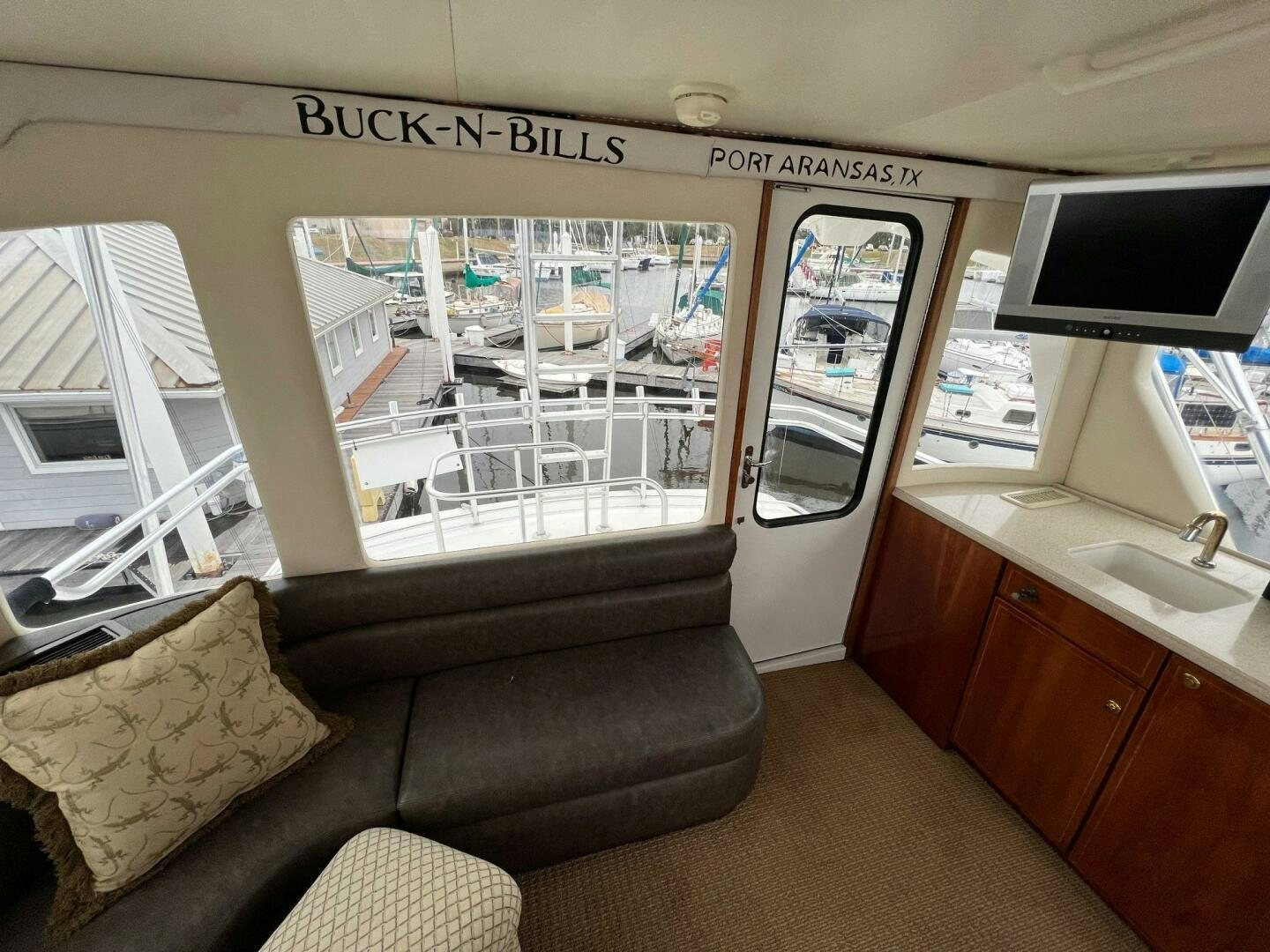 a living room with a couch and a tv aboard BUCK-N-BILLS Yacht for Sale